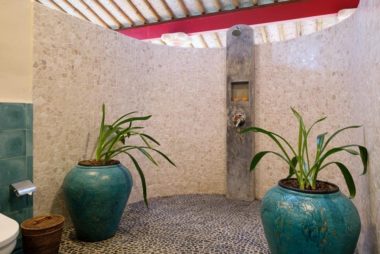 Spacious bathroom shower in natural stone