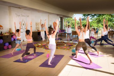 Yoga teacher training students perform the ashta chandrasana posture